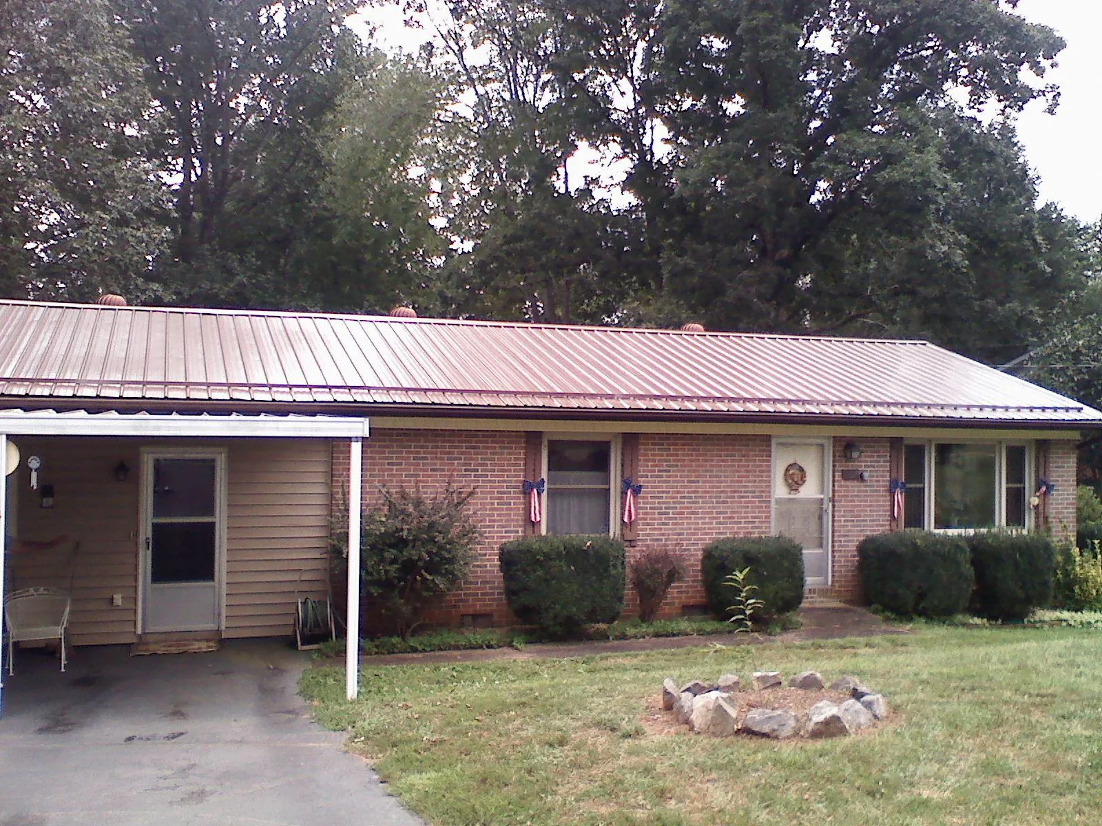Bronze metal roof and carport on a brick ranch home — Roof Repair work by our crew in Wenonah